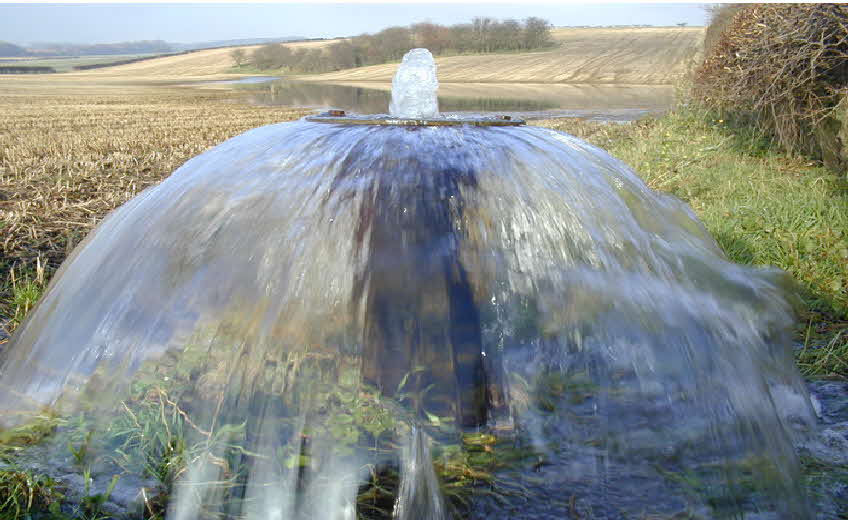 Photograph of an artesian well overflowing